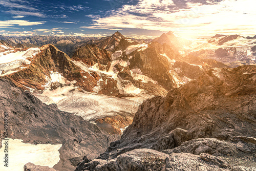 Uri Alps sunset panorama on top of Titlis mount, between Obwalden and Bern. Switzerland. The highest suspension bridge in Europe, 3041 meters.