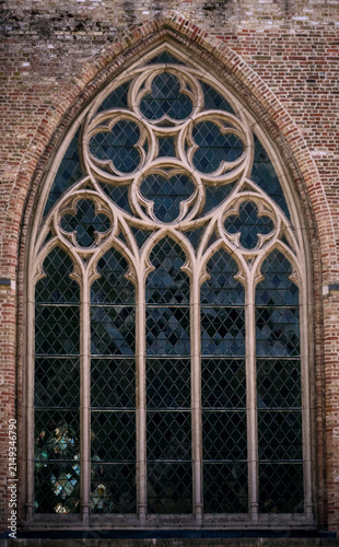 Intricate Gothic Tracery Window of a Historic Brick Building