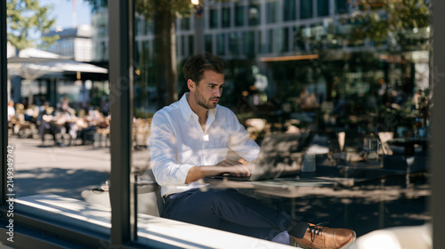 Remote Work: Business Professional Working on Laptop Near Window at Modern Café