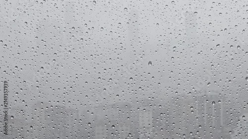 Raindrops Beading and Sliding Down a Window on a Gray Day