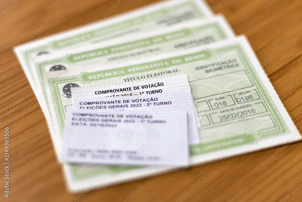 Obraz premium Brazilian voter ID cards (Titulo Eleitoral) with voting receipts from different elections, selective focus