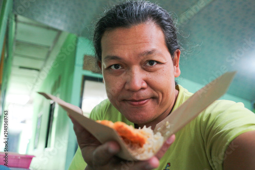 Canvas Print Asian handsome man eating local noodle with spicy sambal uleg