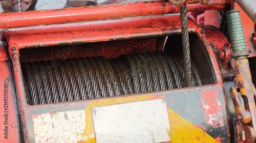 An air winch machine on the drilling rig floor, assembly with iron wirerope sling, the equipment using for lifting heavy equipment in the drilling operation. Industrial equipment object, close-up.