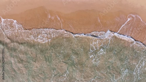 Beautiful sea summer landscape, Waves sea water surface High quality video Bird's eye view, Drone top view waves crashing on sand beach,Nature ocean sea beach background