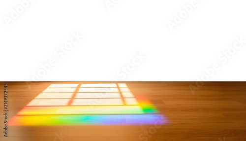 Colorful pencils scattered on wooden surface closeup.