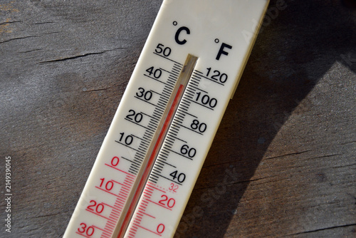 Foto Outdoor thermometer showing extreme high temperature on wooden background