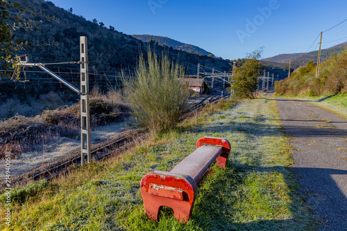 A frosty morning scene with a red bench