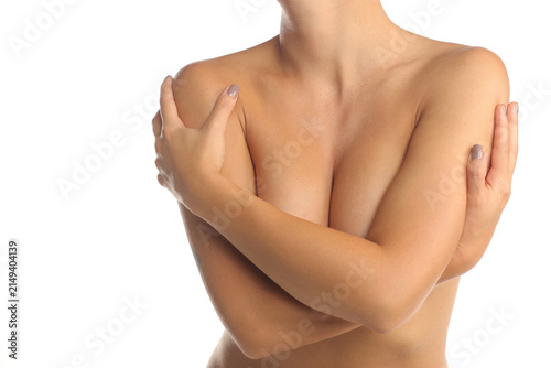 Fotografie Close-up of a woman covering her chest with crossed arms, bare shoulders, on white background