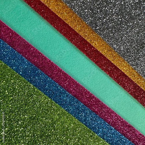 Diagonal stripes of multi-colored glitter paper sheets