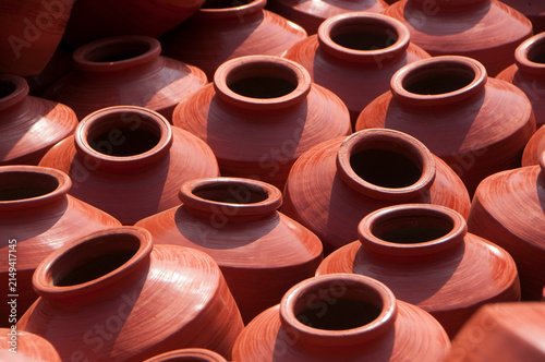 Photography Earthen pot being made using potter's wheel, India