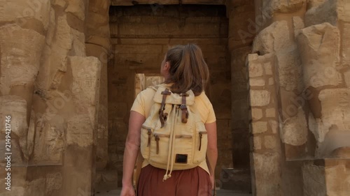Female tourist walking and exploring Karnak Temple in Luxor, Egypt