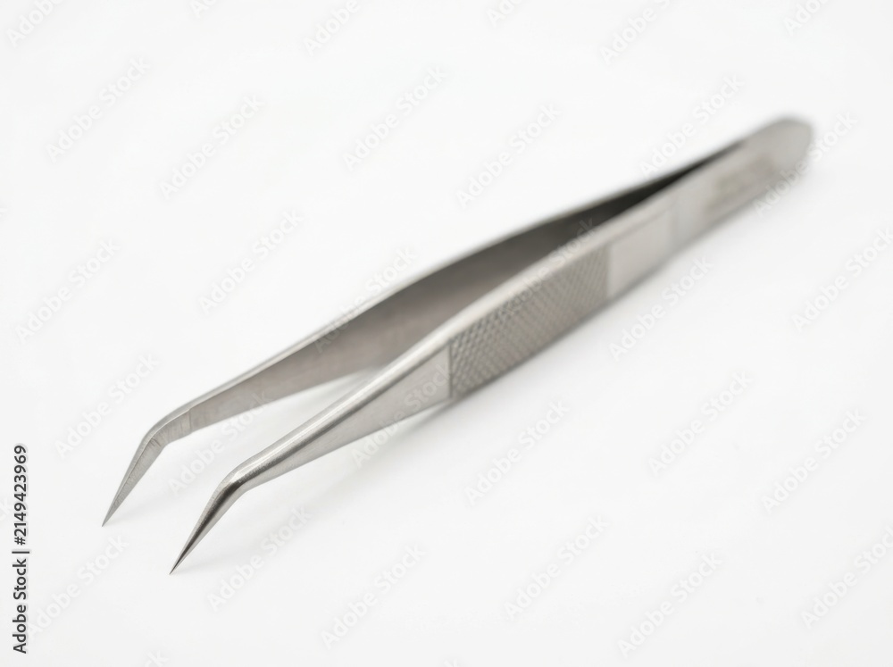 Fototapeta premium Close up of stainless steel curved precision tweezers isolated on white background