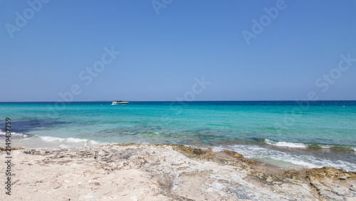 Bild auf Leinwand Turquoise crystal clear water at Ses Illetes beach on a sunny summer day, Formen