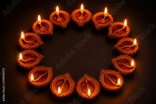 Circular Arrangement of Glowing Clay Diyas for Diwali Festival Background