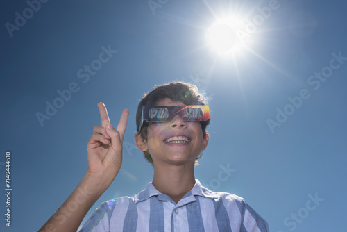 Boy Wearing Solar Eclipse Glasses Under the Sun