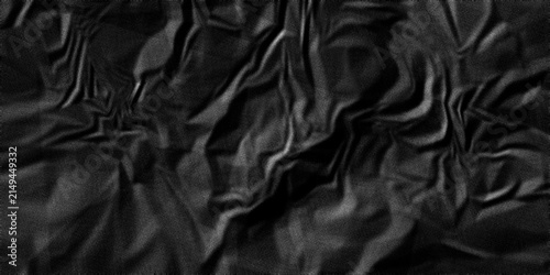 The texture of black fabric is crumpled. Dark background for various purposes with wrinkled surface, natural folds, creases and soft cloth texture for design, poster, artwork and creative projects.