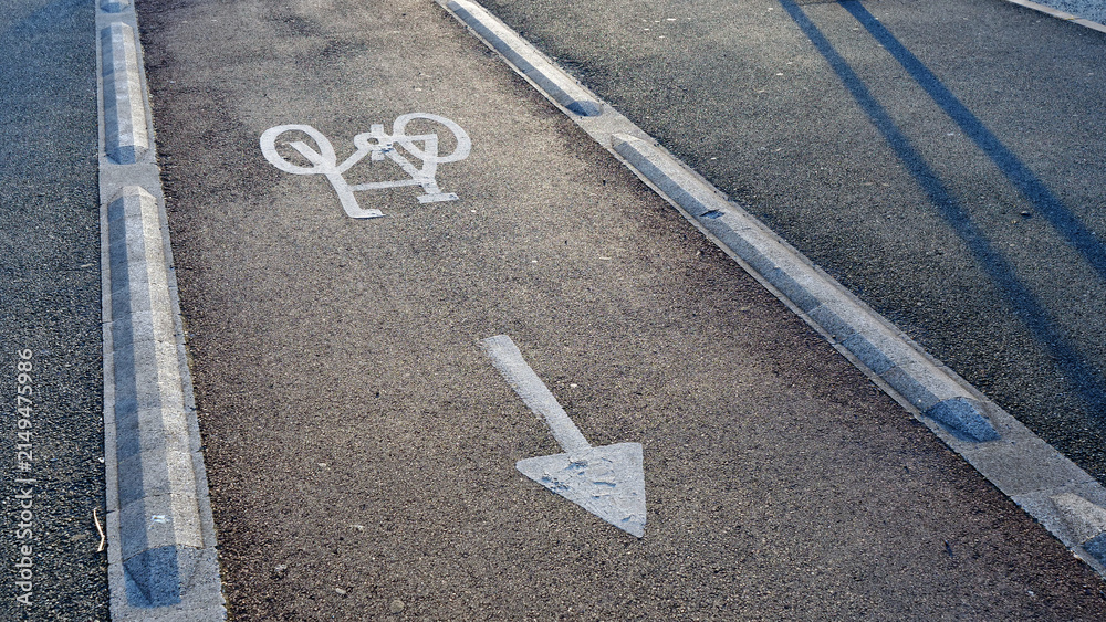 Fototapeta premium Bicycle lane symbol, arrow, asphalt, bike path marking