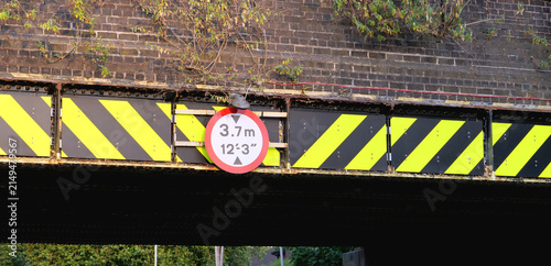 Canvastavla Low bridge height limit sign, hazard stripes, railway overpass