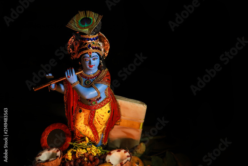 Konstfotografi Beautiful golden Lord Krishna statue with flute decorated for traditional Hindu