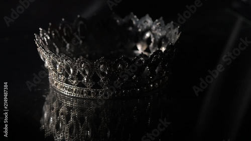 Luxury white gold Crown with Mirror Reflection on Dark Gray Background. Royal Elegance. 4K. Cinematic lighting enhances crystal brilliance and symmetrical reflections