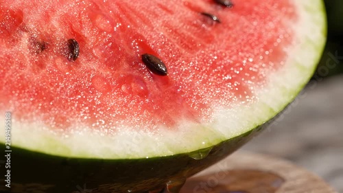 Close up of fresh sliced watermelon with seeds in bright sunlight