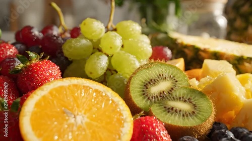 Fresh fruit platter with pineapple orange grapes and kiwi.