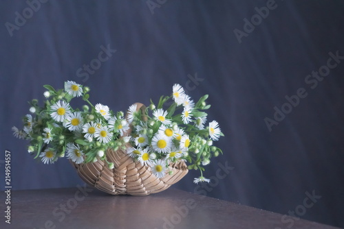Field flowers in a woven wicker basket
