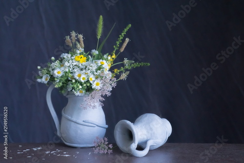 Background with field flowers in a vase