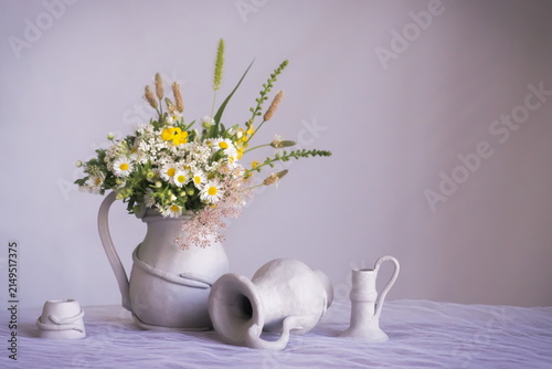 Background with field flowers in a vase