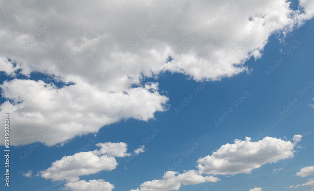 Fototapeta premium Blue sky with soft white clouds forming a natural background