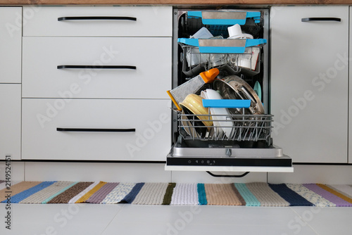 Принти на полотні Open narrow dishwasher filled with dirty dishes