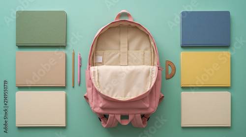 Open Pink Backpack with Blank Pastel Notebooks and School Supplies Flat Lay on Mint Green Background