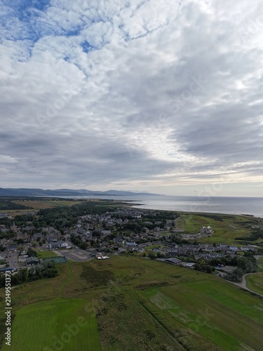 Dornoch is a historic Scottish town beside Dornoch Firth, with cathedral origins in 1224, castle dating 1509–1512, blue skies, and Highland scenery.