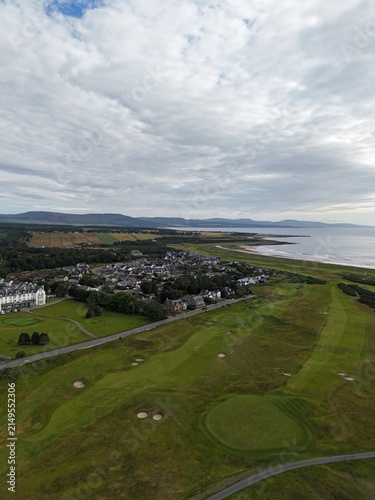 Dornoch is a beautiful Highland town facing the sea, where sunset paints the coast golden, highlighting sandy shores, historic buildings, and landscapes.