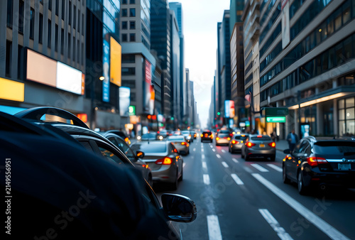 Urban street traffic with cars and Tall buildings in a bustling city at dusk, transportation and infrastructure