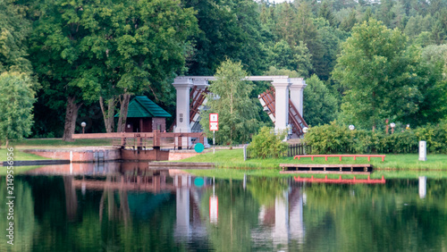 Bridge and structure by the water in a park with trees on a clear day The Augustow Canal on the Vistula River and the Neman River in Belarus Grodno Region on July 25, 2026.