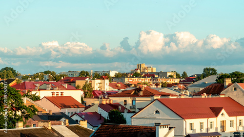 Obraz na plátně City view with red roofs and clouds during sunset in a quiet neighborhood A view