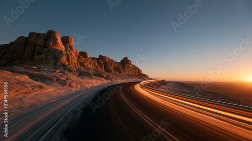 Winding Desert Highway with Light Trails at Sunset
