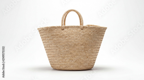 Woven Straw Tote Bag: A natural straw tote bag with sturdy handles sits empty, ready for a day of shopping or a trip to the beach.