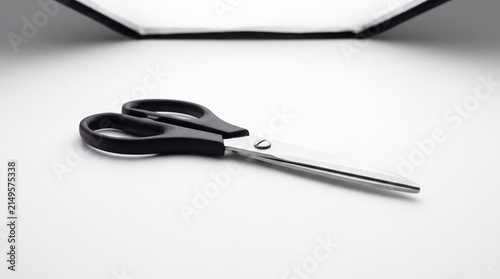 Scissors Ready for Use: A sharp pair of black-handled scissors rests on a clean surface, poised for cutting and crafting.