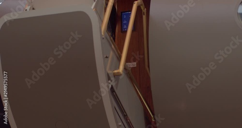 Exclusive airplane access door showcasing sophisticated interior design details. Upscale private jet entrance highlighting refined craftsmanship and modern technological amenities
