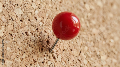 Naklejka Red push pin pinhead inserted into cork board surface