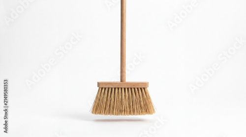 Wooden Broom: A simple, natural wooden broom stands ready for cleaning, its bristles gently fanned out against a clean backdrop.