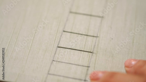Картината върху платно Marking Long Stitch Slots on Green Book Cover
