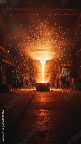 Hot molten metal pouring in metallurgical plant. Industrial foundry process with sparks flying. Smelting steel at high temperature in heavy manufacturing factory. Modern metallurgy production.