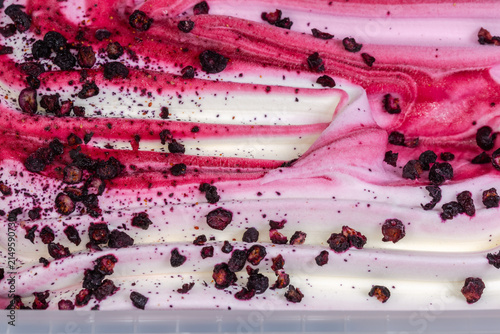 Ice cream berry dessert in container, fragment close-up