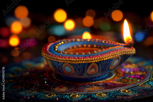 Colorful Diya Oil Lamp with Glowing Flame and Festive Bokeh Lights for Diwali, ai generated