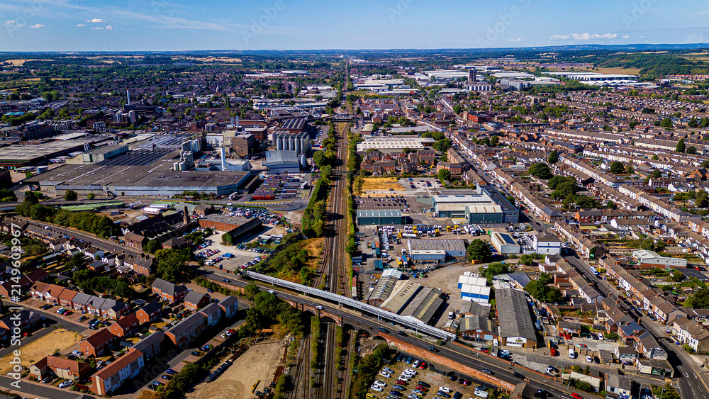 Fototapeta premium Wide aerial vista dividing industrial complex and residential cityscape