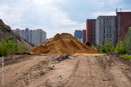 Sand Piles at Urban Construction Site with Residential Buildings