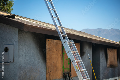 Firemen and women practicing to put out fires on an abandoned house looking at